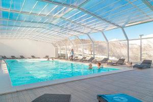 a swimming pool with people in the water at Ciccio Hotel Polsa di Brentonico in Brentonico