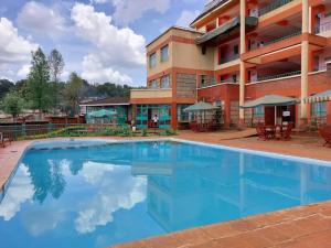 a large swimming pool in front of a building at Westside Hotel Kitale in Kitale
