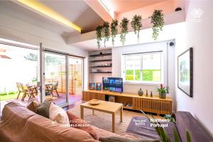 a living room with a couch and a table at PortugalActive Beach Flat in Viana do Castelo