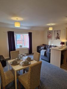 a living room with a table and chairs and a couch at Hereford - Mayflower Coach House, Modern 2 Bedroom Property With Parking, Located South Of Hereford City, Suitable For Small Family, Couple Or Contractors - Sleeps Up To 5 Guests - Hosted by RENTMYHOUSE in Hereford +11 photos