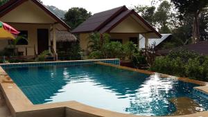 a swimming pool in front of a house at Baansanook Resort & Swimming Pool in Ko Chang