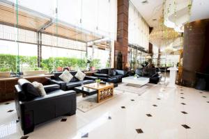 a large living room with black furniture and large windows at Sunday Millennia Hotel in Riyadh