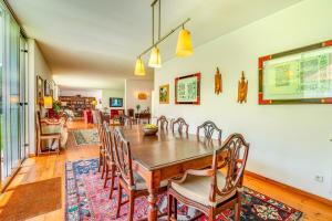 a dining room with a wooden table and chairs at Portugal Active Oliveiras Farm in Viana do Castelo +66 photos