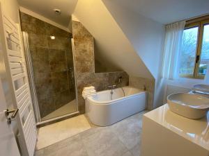 a bathroom with a shower and a tub and a sink at La Tour en Seine in Les Authieux-sur-le-Port-Saint-Ouen +61 photos