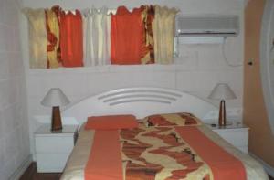 a bed in a room with two tables and two lamps at The Legend Garden Condos in Saint Peter