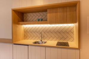 a kitchen with a sink in a wooden cabinet at E7 - Estudio La Orotava in La Orotava