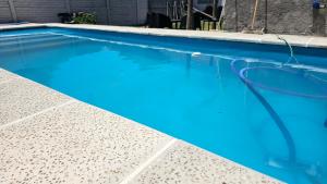 a swimming pool with blue water at Chacaimanta Carhue in Carhué