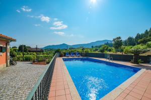 a swimming pool with mountains in the background at Slow Living Countryside House by Portugal Active in Moreira do Lima