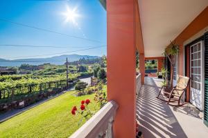a balcony of a house with a view of a vineyard at Slow Living Countryside House by Portugal Active in Moreira do Lima