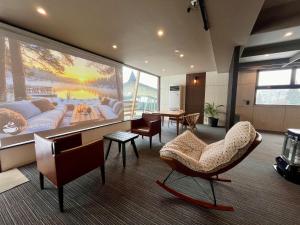 a living room with a large painting on the wall at IshiuchiBASE in Minami Uonuma