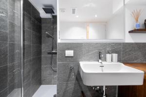 a bathroom with a sink and a shower at A casa di Anna in Madesimo +16 photos