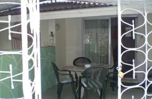 a table and chairs on a porch with a table and chairs at The Legend Garden Condos in Saint Peter
