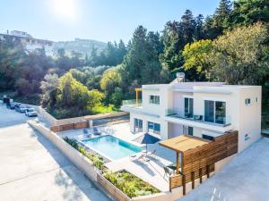 an aerial view of a house with a swimming pool at Villa Anastazia in Koskinou