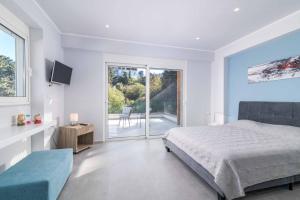 a bedroom with a bed and a view of a patio at Villa Anastazia in Koskinou +15 photos