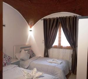 Ένα ή περισσότερα κρεβάτια σε δωμάτιο στο Upper Egypt House