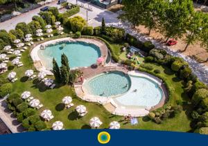an overhead view of a swimming pool with umbrellas at Club del Sole Viareggio Family Collection in Torre del Lago Puccini