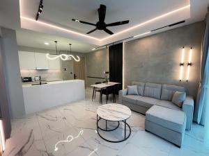 a living room with a couch and a table at Alfa Bangsar by The Homez in Kuala Lumpur
