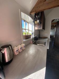 a kitchen with a sink and a counter top at De horizon in Lunteren +10 photos