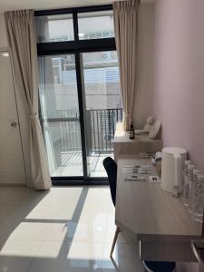 a room with a desk and a large window at 隱居末巷 in San-fen-tzu