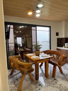 a dining room with a wooden table and chairs at Mountain Sunctuary-TD Solo Unit for friends and family in Baguio +6 photos
