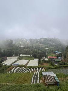 an aerial view of a farm with buildings and crops at Mountain Sunctuary-TD Solo Unit for friends and family in Baguio