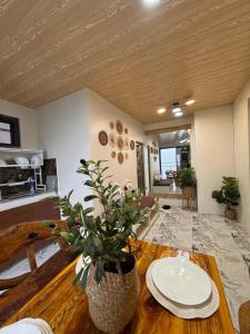 a living room with a table with plates on it at Mountain Sunctuary-TD Solo Unit for friends and family in Baguio