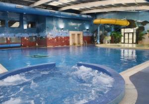 a large swimming pool with a water slide at Billing Aquadrome , Hailsham 2 Bedrooms, BLP60 in Northampton