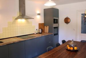 a kitchen with a table with a bowl of oranges on it at Casa do Paço in Paredes de Coura