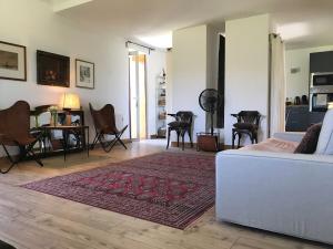 a living room with a white couch and a rug at Casa do Paço in Paredes de Coura