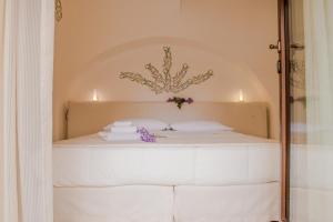 Uma cama ou camas num quarto em Dimora Dell'Osanna