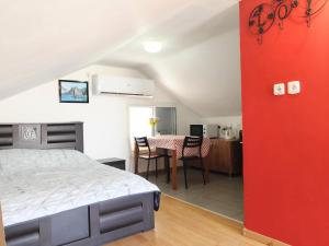 a bedroom with a bed and a table in a room at Guest House VeryMary Eilat Stydio in Eilat