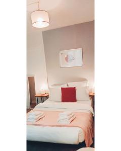 a hotel room with a bed with a red pillow at Po1-TPSA17-3D- ROOM Paris 17ème in Paris