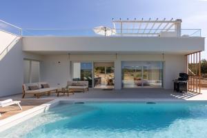 a house with a swimming pool and a patio at Villa Santa Lucia ZadarVillas in Turanj