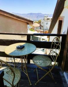 a table and two chairs on a balcony at Guest House VeryMary Eilat Stydio in Eilat