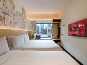Ibis Singapore on Bencoolen - Newly Renovated客房内的一张或多张床位