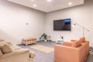 a living room with two couches and a flat screen tv at E7 - Estudio La Orotava in La Orotava