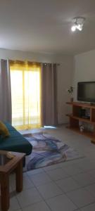 a living room with a couch and a tv at Holiday Spot in Portimão