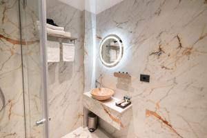 a bathroom with a sink and a shower at Ecletico Villa in Bucharest