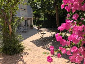 a group of pink flowers on a brick patio at Garden Suites in Corfu