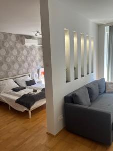 a living room with a couch and a bed at Peter's Cosy Budapest Suite in Budapest