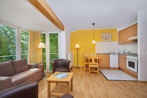 a living room with a couch and a table at Haus Strandperle in Zinnowitz
