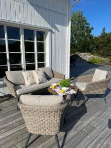a patio with a couch and chairs and a table at Hytteperle in Risør