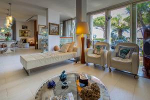 a living room with a couch and chairs and a table at Villa Olimpia in Mondello