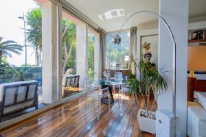 a living room with a table and a tv at Villa Olimpia in Mondello