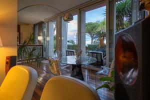 a dining room with a glass table and chairs at Villa Olimpia in Mondello