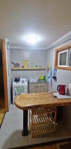 a kitchen with a wooden table in a room at Rincón Puyehue Primer Nivel in Puyehue