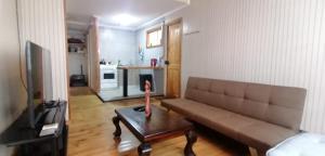 a living room with a couch and a table at Rincón Puyehue Primer Nivel in Puyehue