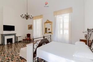 a bedroom with a bed and a fireplace at Palazzo Grassi by Vivimy in Gallipoli