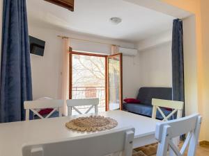 a dining room with a white table and chairs at Niko Apartments in Drvenik