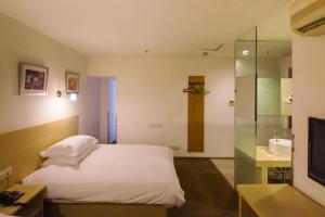 a hotel room with a bed and a sink at Motel Shanghai Pudong Lianyang New International Expo Centre in Shanghai +23 photos